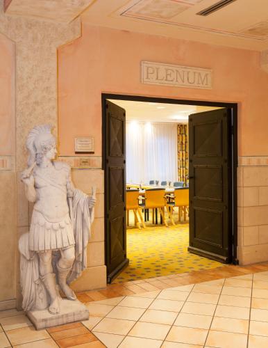 a statue of a woman standing next to a door at Dorint MARC AUREL Spa & Golf Resort in Bad Gögging