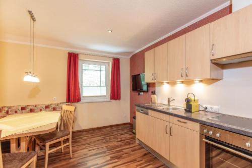 a kitchen with a table and a dining room at Appartement MonAlisa in Sölden