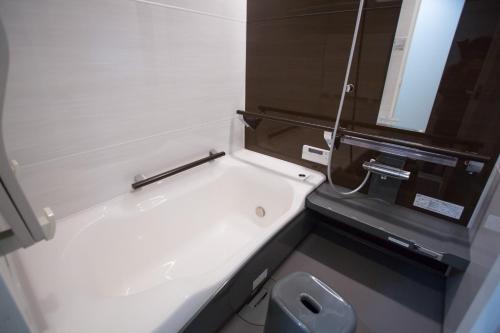 a small bathroom with a toilet and a mirror at Kyo Obataya in Kyoto