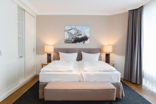 a bedroom with a large bed and a large window at ConventGarten Hotel & Restaurant - am Nord-Ostsee-Kanal in Rendsburg