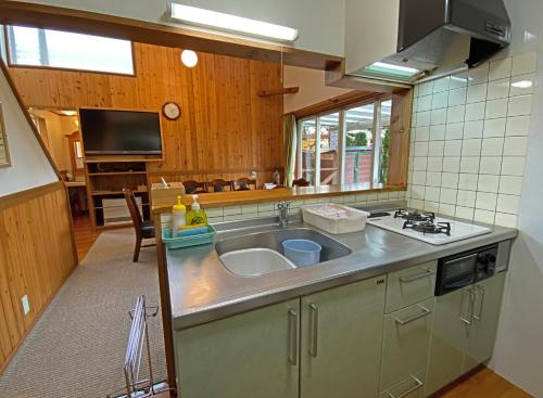 a kitchen with a sink and a stove at Lake Villa Kawaguchiko in Fujikawaguchiko