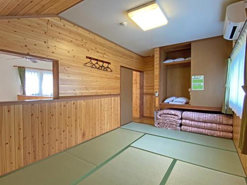 a room with wood paneling and a room with towels at Lake Villa Kawaguchiko in Fujikawaguchiko