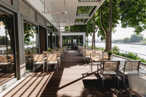 a restaurant with tables and chairs in a building at ConventGarten Hotel & Restaurant - am Nord-Ostsee-Kanal in Rendsburg