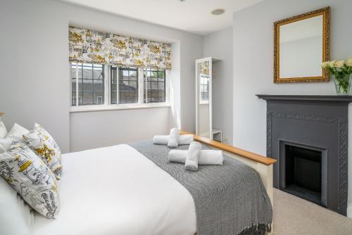 a bedroom with a bed and a fireplace at Castle Properties:Eton-The College in Windsor