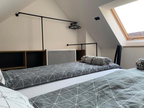 two beds in a room with a window at 18Home apartments, Mojstrana in Mojstrana