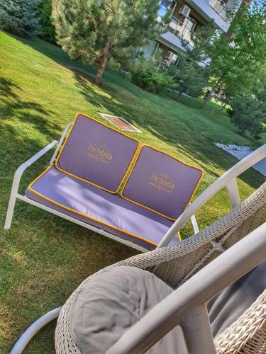 avisor on a wicker chair in a yard at Portobella Airport Aparthotel - Self Check in in Otopeni