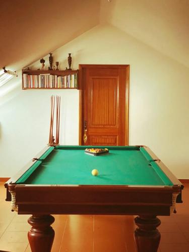 a pool table with a ball on top of it at Casa Ana Rosa in Arcos de Valdevez