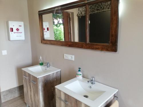 a bathroom with two sinks and a mirror at Casa Marina in Caldas de Reis