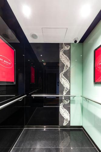 a room with a glass wall with a staircase at The Mercer in Hong Kong
