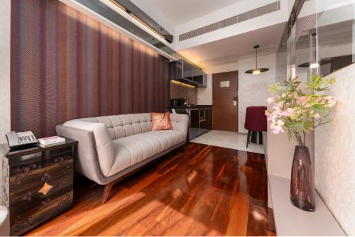 a living room with a couch and a table at The Mercer in Hong Kong