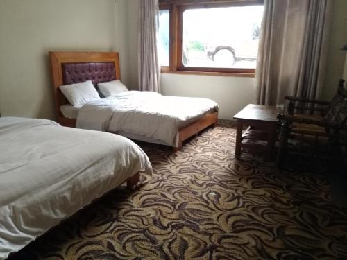Ένα ή περισσότερα κρεβάτια σε δωμάτιο στο Tourist Inn Hotel