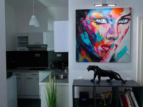 a dog statue on a table in a kitchen with a painting at GelsenDesign - Gemütliches Studio-Apartment in Gelsenkirchen