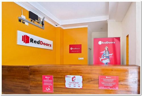 a store with orange walls and signs on the wall at RedDoorz Syariah near Solo Square Mall in Lawean