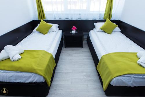 two beds sitting next to each other in a room at Antari in Slatina