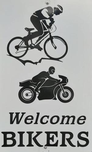 two drawings of a man riding a bike and a motorcycle at B&B La corte di Stelio in Pisa