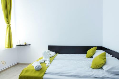 a bedroom with a bed with towels on it at Antari in Slatina