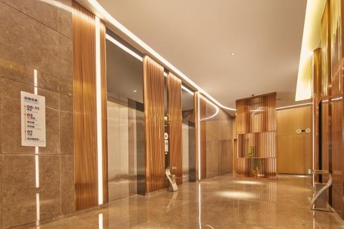 a lobby of a building with a sign on the wall at Holiday Inn Express Hangzhou East Station, an IHG Hotel in Hangzhou