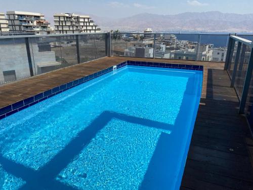 a swimming pool on the roof of a building at Stunning Penthouse with sea views and private heated pool in Eilat