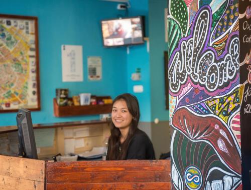 a woman sitting at a counter in a restaurant at Onefam Budapest in Budapest