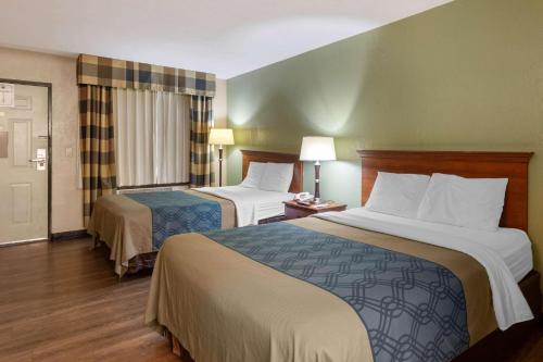 a hotel room with two beds and a window at Econo Lodge Belton - Kansas City South in Belton