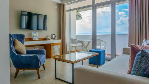 a living room with a couch and a table at Hotel & Spa Tino Sveti Stefan in Ohrid