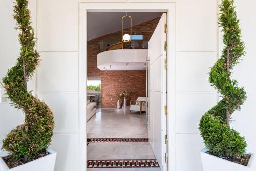 a hallway with an open door with plants at Giakoumakis Luxury-Private Villa in Xirón Khoríon