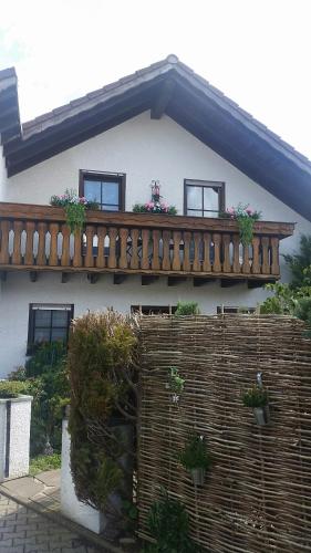 a house with a wooden balcony on top of it at Günther Fernschild in Trochtelfingen