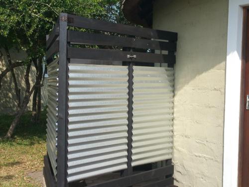 a wooden gate on the side of a house at Izulu Eco Lodge in Sodwana Bay