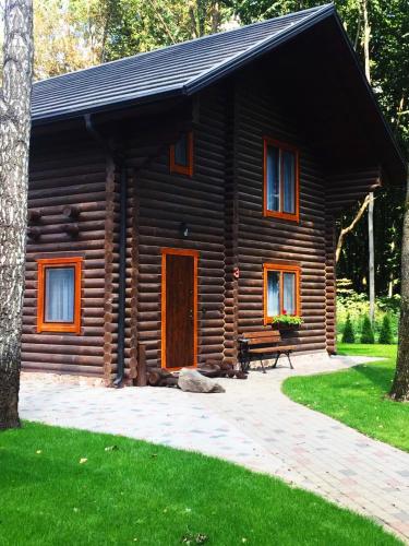 a log cabin with a bench in front of it at Turiyske Podvir'ya in Blazhennik