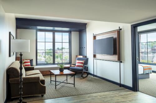 a living room with a couch and a tv at Hammetts Hotel in Newport
