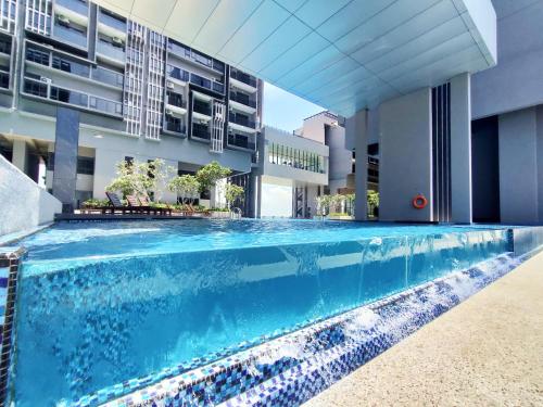a swimming pool in front of a building at Imperio Homestay Private Bathtub-FreeParking & Wifi in Melaka
