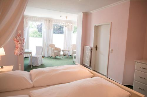 a bedroom with pink walls and a bed in a room at Alter Landkrug in Nortorf