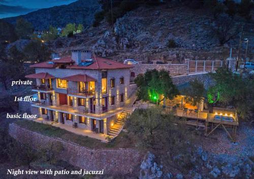 an aerial view of a house with patio and fence at AlmondHouse Suites with Fireplace - ADULTS ONLY in Arachova