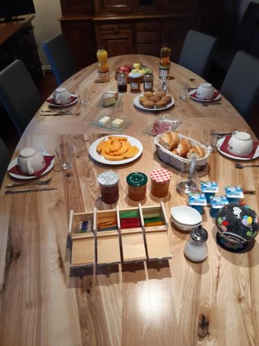a wooden table with food on top of it at le domaine du chaffard in Les Avenières