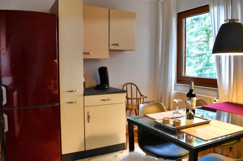 a small kitchen with a table and a refrigerator at Mediterran-Skandinavisch - Outdoorwhirlpool ganzjährig in Burgthann