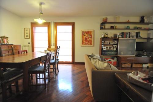 a living room and dining room with a table and a couch at Appartamento Cavalli in Mestre