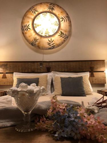 a bedroom with a bed with a large mirror on the wall at POUSADA CHARLOTTE in Tiradentes