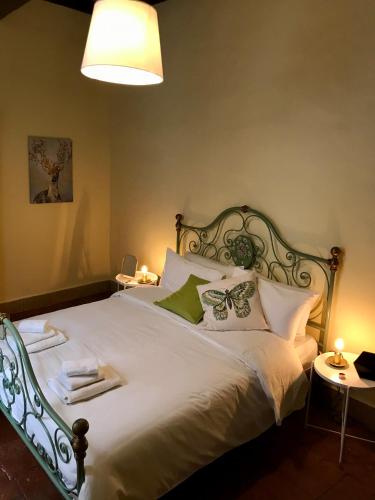a bedroom with a large bed with white sheets and butterfly pillows at La Casa di Helena in Stroncone