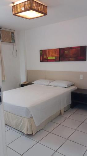 a bedroom with a large white bed in a room at Apartamento Atins 201 - Gran Lencois Flat Residence in Barreirinhas