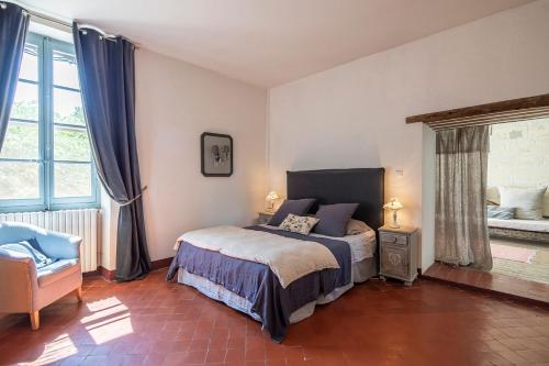 1 dormitorio con 1 cama, 1 silla y ventanas en Les volets bleus-Maillane, en Maillane