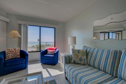 a living room with two chairs and a couch at Anna Maria Island Beach Sands 101 in Bradenton Beach