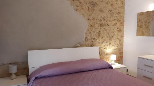 a bedroom with a bed and two night stands at La Limonaia Country House in Monteriggioni
