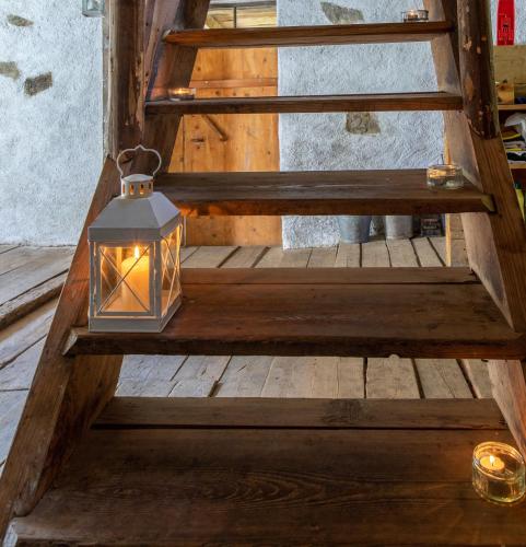 a lantern on a wooden stairwell with at Unplugged Almhütte Waldbauer in Reichenfels