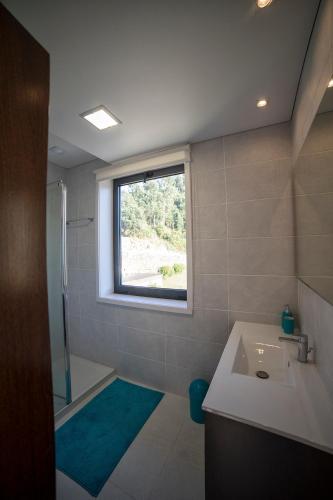 a bathroom with a sink and a window at Quinta da Casa Nova in Santo Tirso