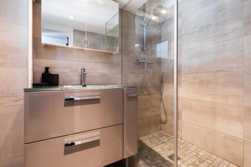 a bathroom with a sink and a shower at DIFY Boileau - Foch in Lyon