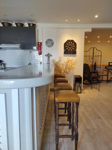 a bar in a restaurant with stools in a room at Blife Sun Hostel & Rooms in Faro