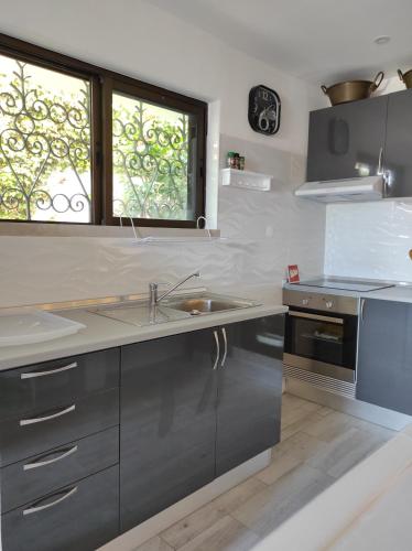 a kitchen with a sink and a window at Blife Sun Hostel & Rooms in Faro