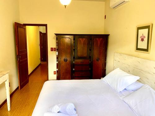 a bedroom with a large white bed in a room at Hotel Vila Bavária Petrópolis in Petrópolis