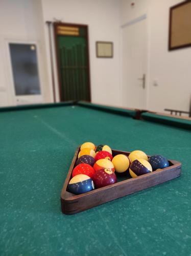 a pool table with a tray of balls on it at Blife Sun Hostel & Rooms in Faro