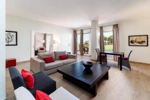 a living room with a couch and a table at Fairplay Golf & Spa Resort in Benalup Casas Viejas